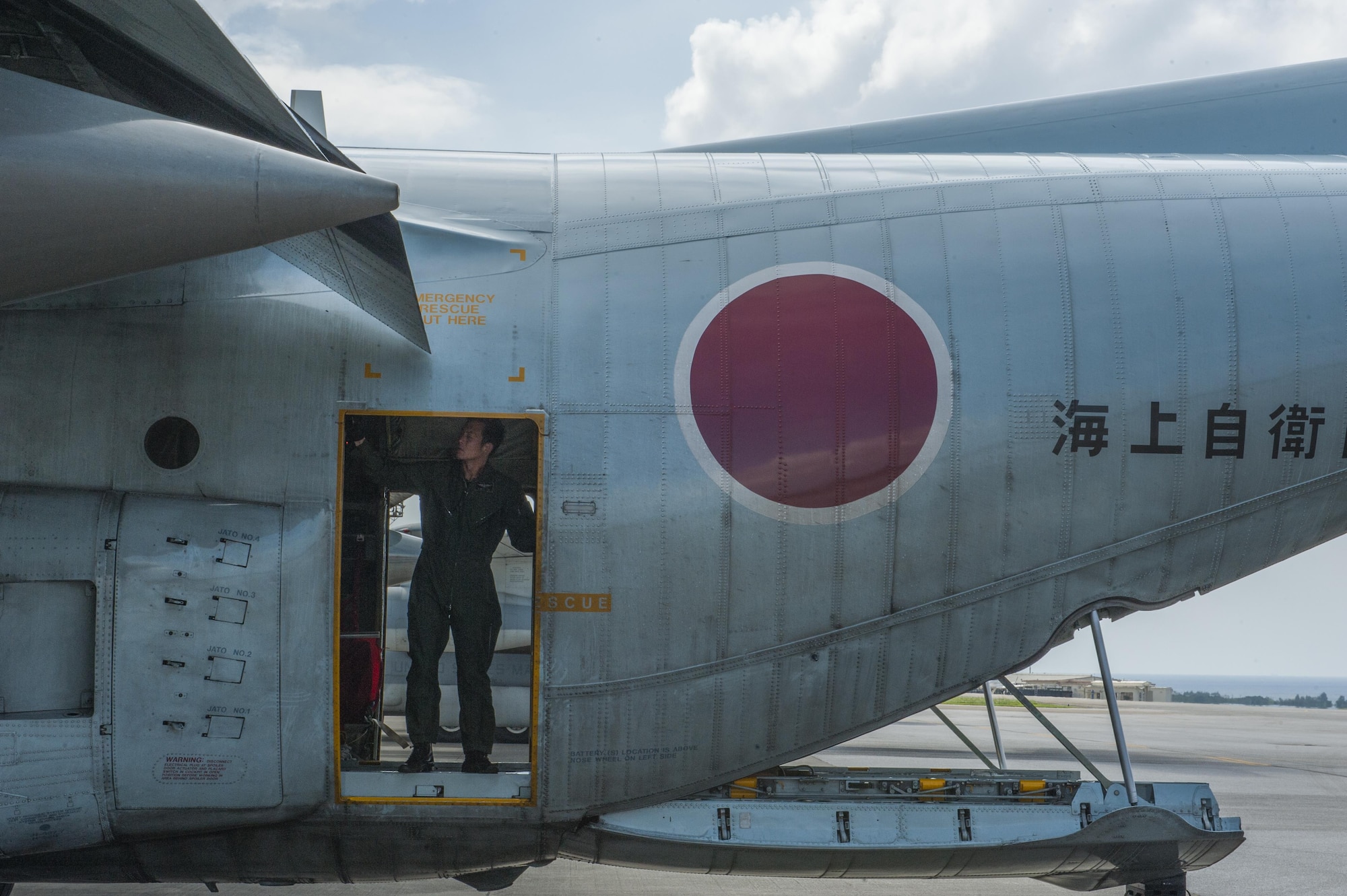 A member of the Japan Air Self-Defense Force aboard a JASDF C-130 Globemaster takes part in Exercise Keen Sword on the flightline Oct. 30, 2016, at Kadena Air Base, Japan. The JASDF personnel transferred mock munitions to members of the 18th Munitions Squadron for storage and transfer to the U.S. Navy on White Beach and then to the Japan Maritime Self-Defense Force. (U.S. Air Force photo by Airman 1st Class Nick Emerick /Released)