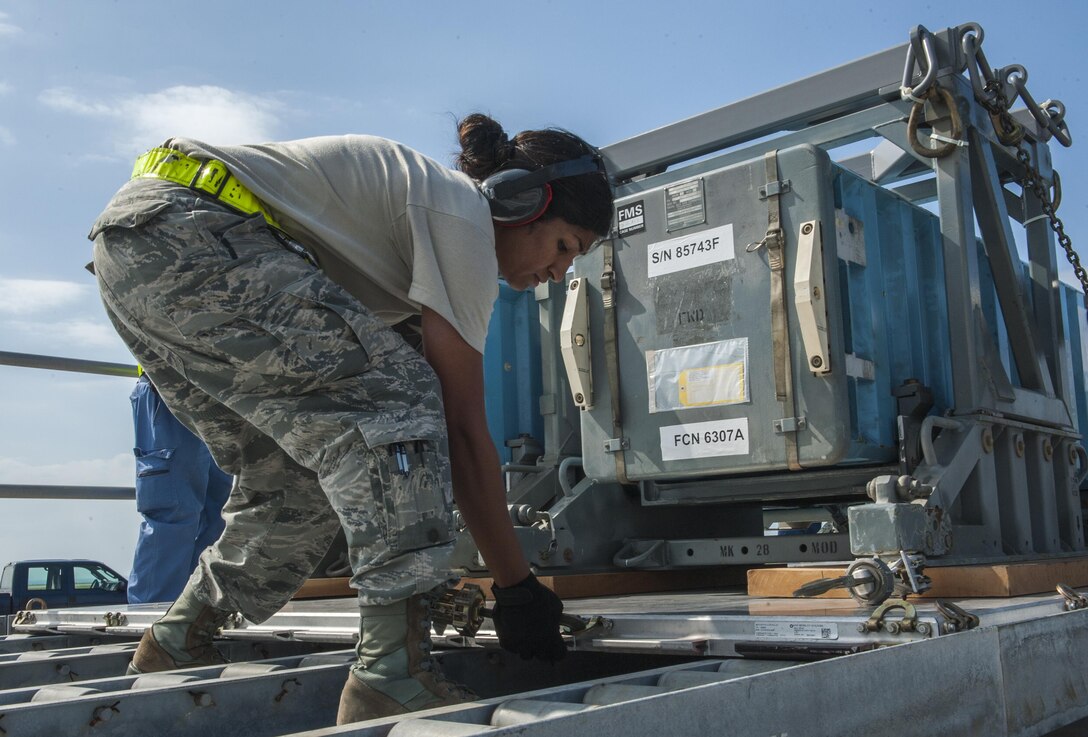 U.S. Air Force Staff Sgt. Lincy Thomas, 733rd Air Mobility Squadron aircraft services supervisor, secures mock munitions for Exercise Keen Sword Oct. 30, 2016, on the flightline at Kadena Air Base, Japan. Japanese Air Self-Defense Force members transferred mock munitions to members of the 18th Munitions Squadron for storage and transfer to the U.S. Navy on White Beach and then to the Japanese Maritime Self Defense Force. (U.S. Air Force photo by Airman 1st Class Nick Emerick /Released)