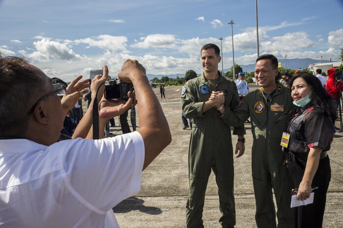 U.S. Marine Corps Lt. Col. Stephen N. McClune, commanding officer of Marine All-Weather Fighter Attack Squadron (VMFA (AW)) 225, and Indonesian Air Force Col. Irwan Pramuda, commander of Air Squadron 3, pose for a photo with Indonesian media after an opening ceremony to mark the beginning of exercise Cope West 17 at Sam Ratulangi International Airport, Indonesia, Nov. 1, 2016. Cope West 17 is the first exercise held in Indonesia in 19 years involving U.S. Marines and the Indonesian Air Force. (U.S. Marine Corps photo by Cpl. Aaron Henson)
