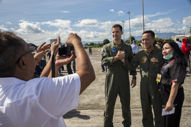 U.S. Marine Corps Lt. Col. Stephen N. McClune, commanding officer of Marine All-Weather Fighter Attack Squadron (VMFA (AW)) 225, and Indonesian Air Force Col. Irwan Pramuda, commander of Air Squadron 3, pose for a photo with Indonesian media after an opening ceremony to mark the beginning of exercise Cope West 17 at Sam Ratulangi International Airport, Indonesia, Nov. 1, 2016. Cope West 17 is the first exercise held in Indonesia in 19 years involving U.S. Marines and the Indonesian Air Force. (U.S. Marine Corps photo by Cpl. Aaron Henson)