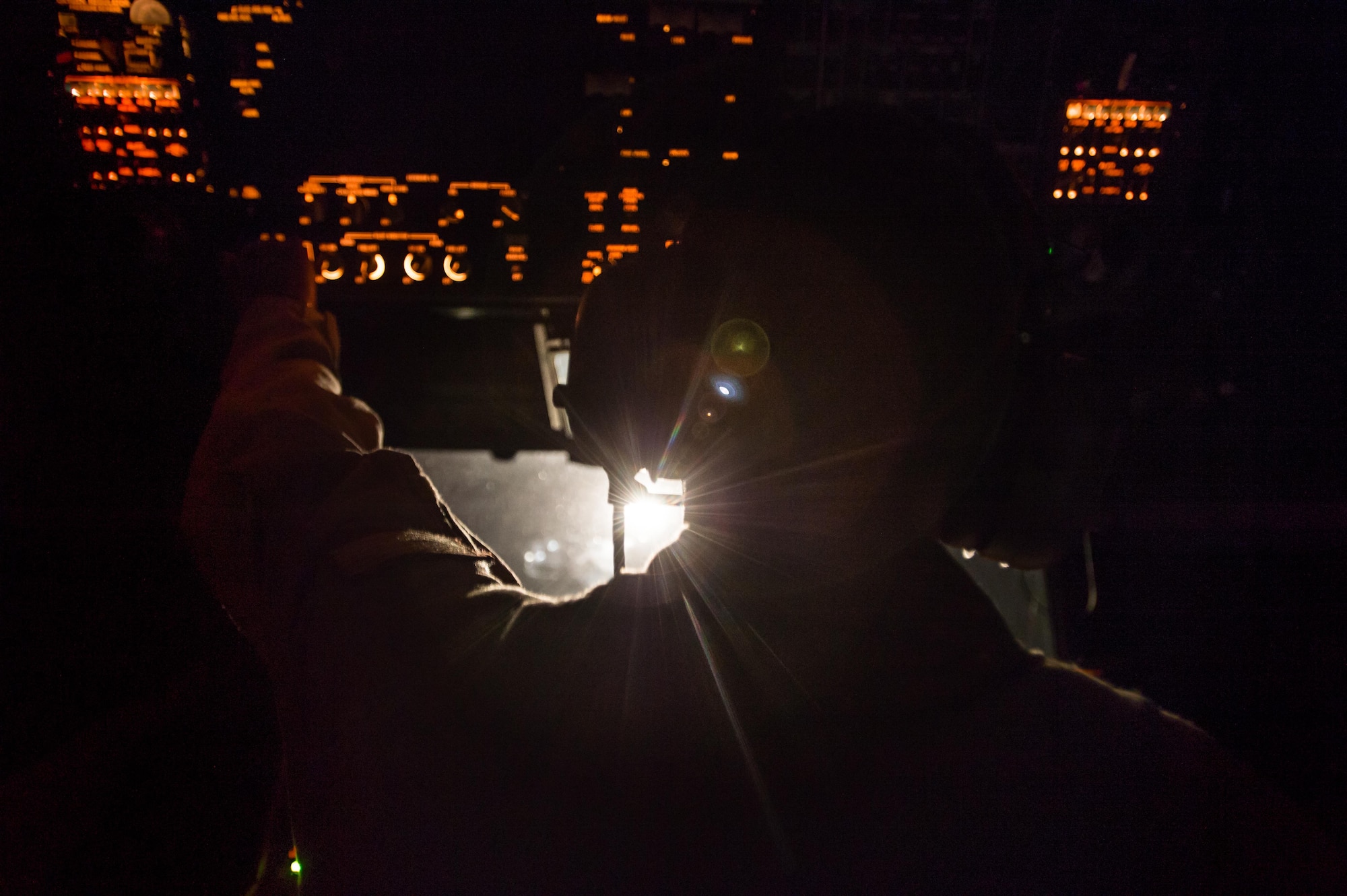 A U.S. Air Force KC-10 Extender boom operator prepares for a refueling sequence with a Royal Australian Air Force F/A-18 Hornet from an undisclosed location in Southwest Asia, Oct. 24, 2016. KC-10 boom operators sit in the rear of the air craft to operate the boom and communicate with recieving aircraft. The aircraft has the capability of delivering fuel at 1,100 gallons per minute providing refueling support to several coalition airframes working to liberate the city of Mosul, Iraq. (U.S. Air Force photo by Senior Airman Tyler Woodward)