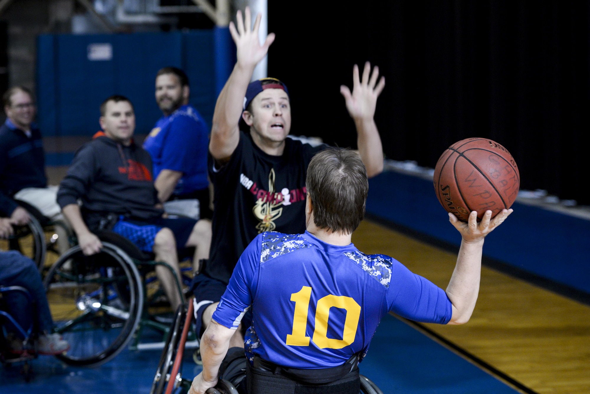 Phil Hogue, from Nephi, Utah, brother of Master. Sgt. Samuel Hogue, 445th Security Forces Squadron, attempts to block a pass by Mr. Keith Cable, Air Force Research Laboratory system administrator, during the 2nd annual wheelchair basketball game held as part of the National Disability Awareness Month activities, Oct. 26, at Wright-Patterson Air Force Base. Hogue who was visiting his brother took the opportunity to participate in this awareness month activity to feel what it is like to play this popular sport while bound to a wheelchair. (U.S. Air Force photo/ Wesley Farnsworth)