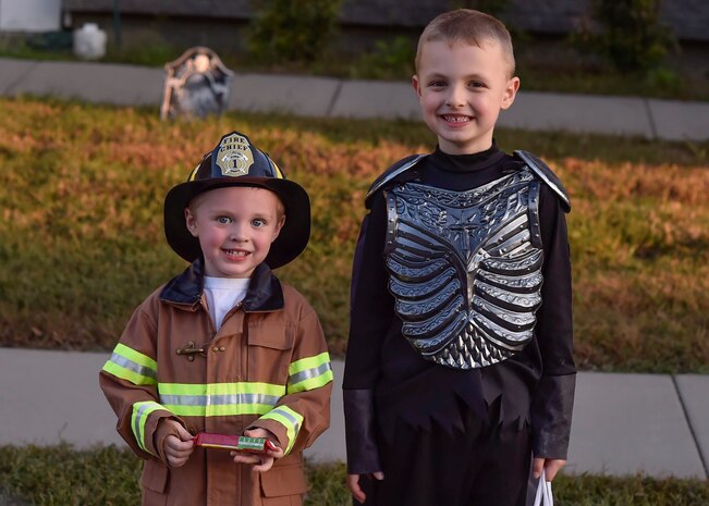 Jaxon Holliday, left, and Aiden Burris, right, members of Team Charleston, trick-or-treat during Pumpkin Patrol here, Oct. 31, 2016. On Halloween, members of Joint Base Charleston volunteered for Pumpkin Patrol to walk through base housing on the lookout for injured or lost children.