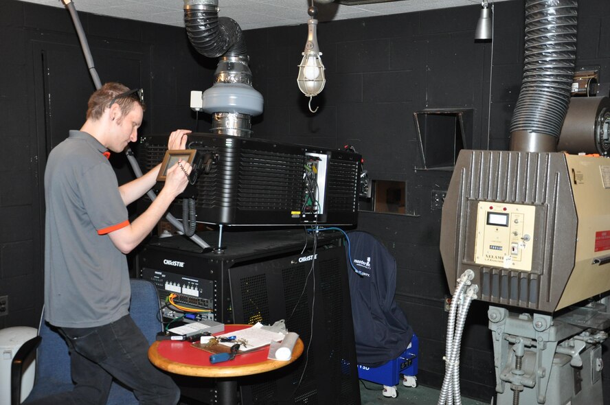 Joshua Adamson, Army & Air Force Exchange Service theater projectionist, prepares to download a digital movie for a weekend show at the Wright-Patterson Air Force Base theater. (U.S. Air Force photo/W. Eugene Barnett Jr.)