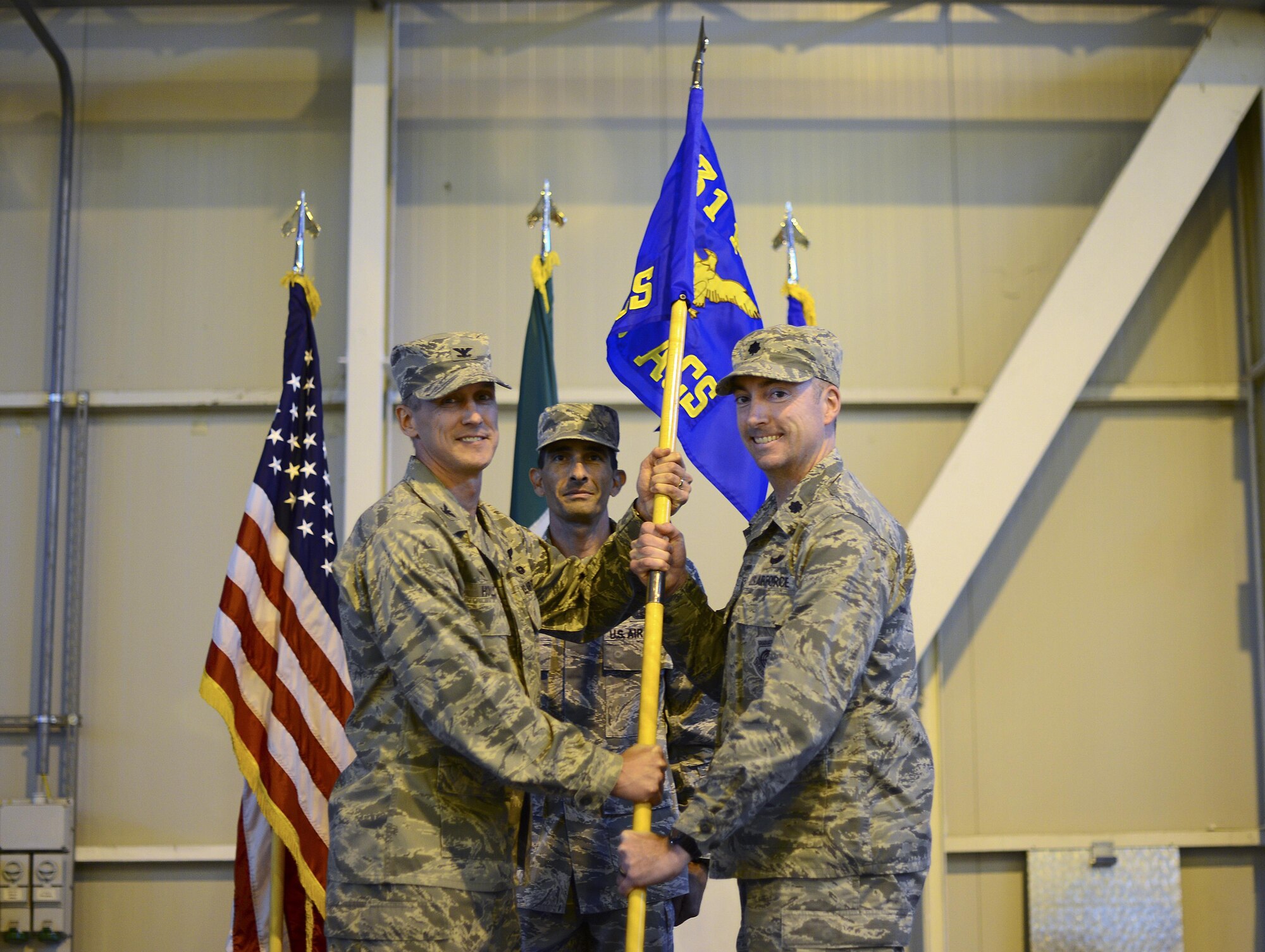 Col. Craig M. Hollis, 31st Operations Group commander, passes the guidon to Lt. Col. Aaron Gibney, 606th Air Control Squadron commander, during the 606th ACS activation ceremony at Aviano Air Base, Italy on Nov. 1, 2016. The 606th ACS began their relocation from the 52nd Fighter Wing, Spangdahlem Air Base, Germany in February 2016. The unit was added to the 31st OG as a part of the European Infrastructure Consolidation.  (U.S. Air Force photo by Senior Airman Areca T. Bell/Released)