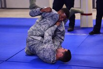 Airman 1st Class Perez Buford tries to escape the grasp of Airman 1st Class Gabriel Serrano during 50th Security Forces Squadron combatives training at Schriever Air Force Base, Colorado, Monday, Oct. 31, 2016. Members must learn how to escape an attacker and counter to restrain them until back up arrives to detain or apprehend the suspect. (U.S. Air Force photo/Brian Hagberg)