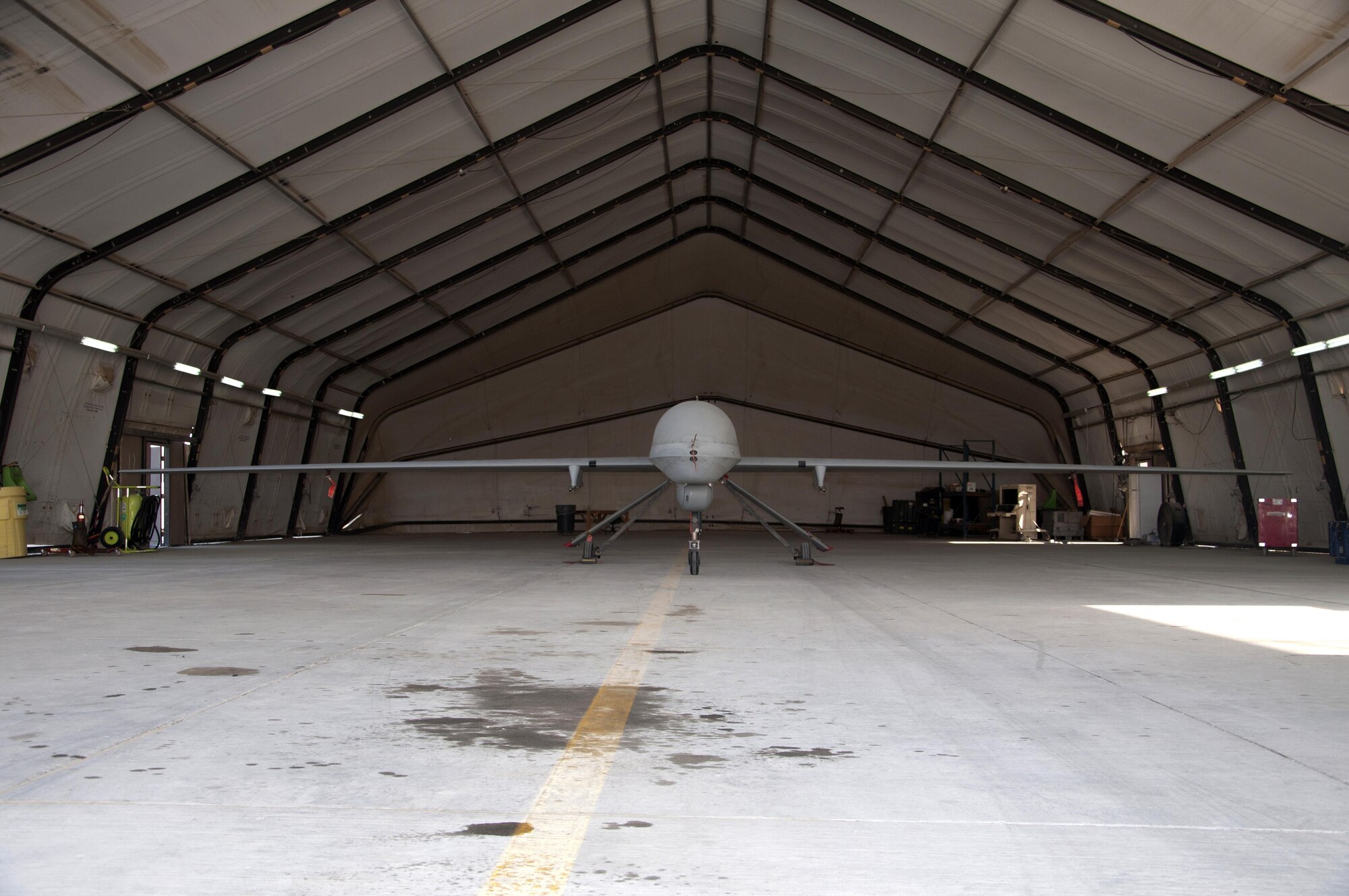 A MQ-1 Predator sits in the hangar in an undisclosed location in Southwest Asia, Oct. 20, 2016. The 386th Air Expeditionary Wing beds down and supports the MQ-1 in order to gather intelligence, surveillance and reconnaissance, and perform strike missions. (U.S. Air Force photo by Master Sgt. Anika Jones/Released)