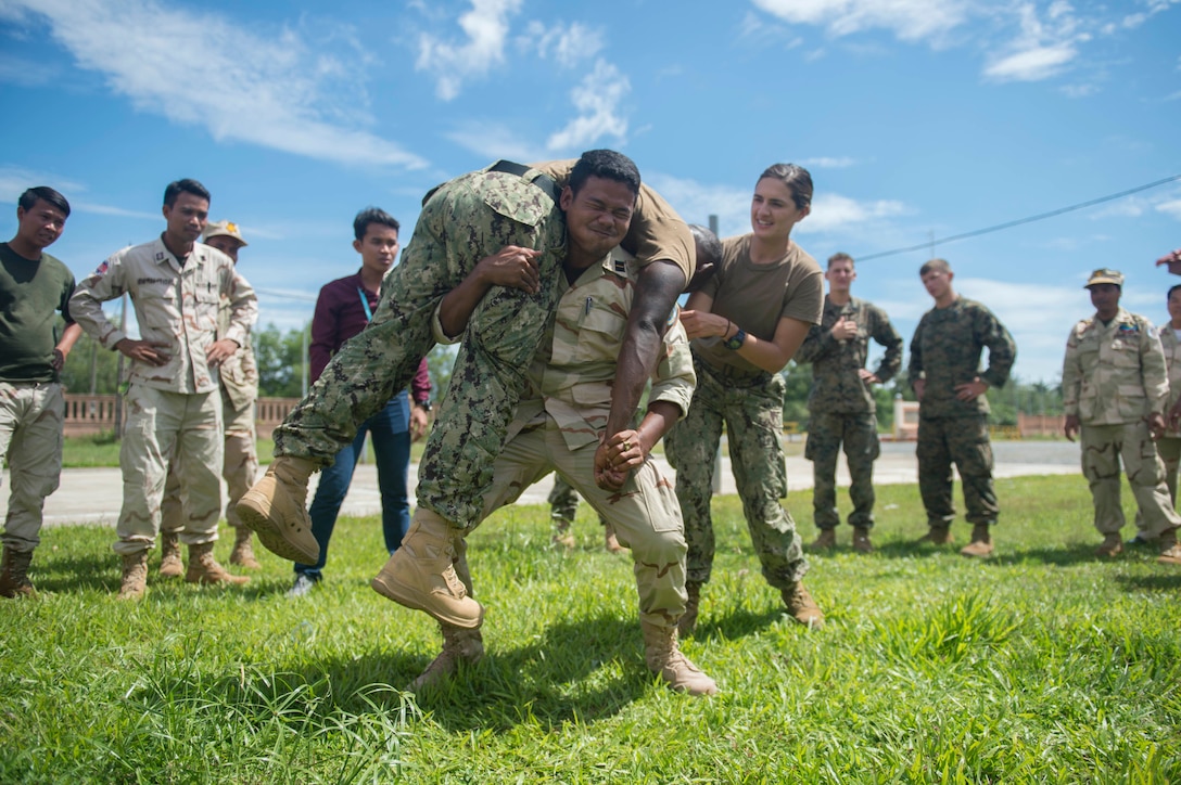 A Cambodian sailor performs a fireman’s carry as U.S. Navy Lt. Rachael Hayden observes during first responder training for Cooperation Afloat Readiness and Training Cambodia 2016 in Sihanoukville, Cambodia, Nov. 2, 2016. Hayden is assigned to Naval Mobile Construction Battalion 5. Navy photo by Chief Petty Officer Lowell Whitman