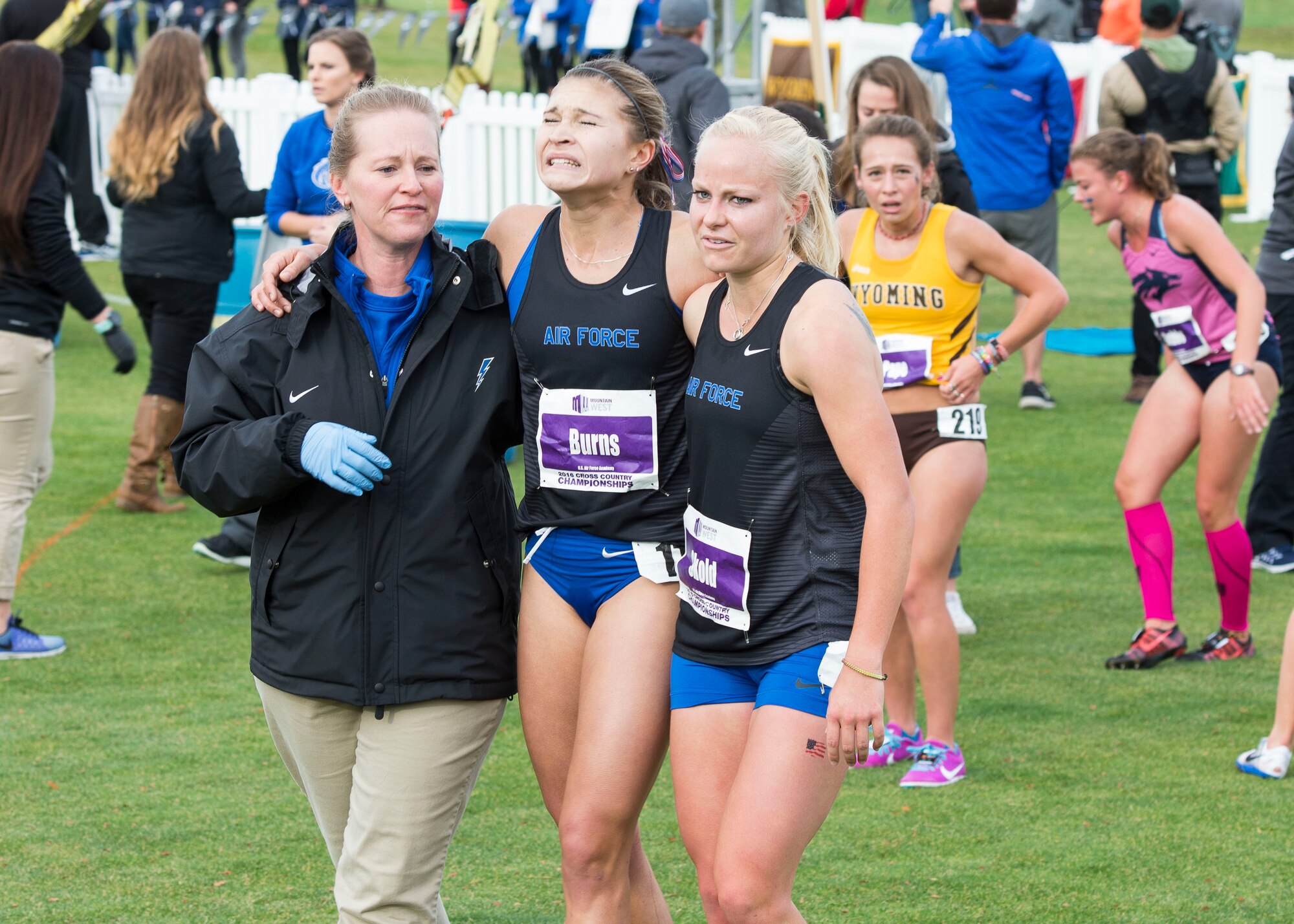 Team members help Cadet Shanna Burns out of the finish area after finishing the Mountain West Conference Championship race Oct. 28, 2016, at the Falcon Crest Golf Club in Kuna, Idaho. Many runners received medical attention after crossing the finish line in the six-kilometer race. (U.S. Air Force photo by Airman 1st Class Chester Mientkiewicz/Released)