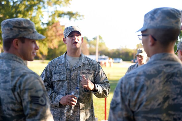 U.S. Air Force Staff Sgt. Noah Paxton, 633rd Civil Engineer Squadron fire emergency services crew chief, explains a task during a Prime Base Engineering Emergency Force readiness challenge at Joint Base Langley-Eustis, Va., Oct. 25, 2016. Paxton assisted at the fire department station, where 633rd CES members had to perform tasks such as climb a ladder a certain amount of times. (U.S. Air Force photo by Senior Airman Kimberly Nagle)