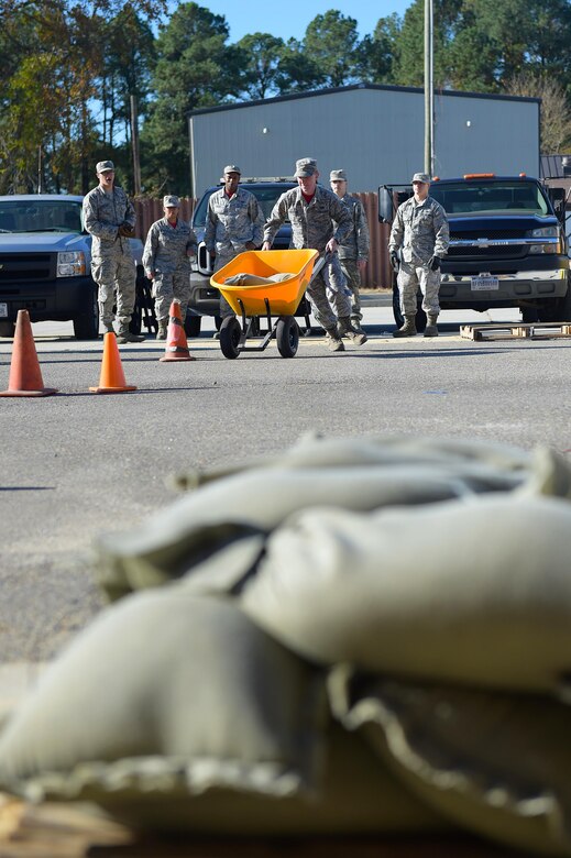 Members of the 633rd Civil Engineer Squadron participate in a Prime Base Engineering Emergency Force readiness challenge at Joint Base Langley-Eustis, Va., Oct. 25, 2016. The training had 12 stations set-up, each had representative from that specialty explaining how to complete a task, while keeping score, helping and encouraging the teams along the way. (U.S. Air Force photo by Senior Airman Kimberly Nagle)