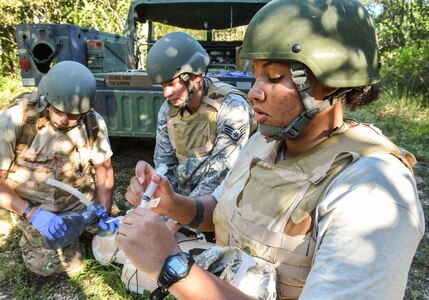 Staff Sgt. Cassandra Bayerl, student and paramedic with the 59th Medical Wing, prepares an epinephrine shot for a simulated patient during the Paramedic Recertification Course on Joint Base San Antonio-Lackland, Texas, Sept. 19, 2016. Students underwent five days of didactic and two days of field training exercises. (U.S. Air Force photo/Staff Sgt. Michael Ellis)