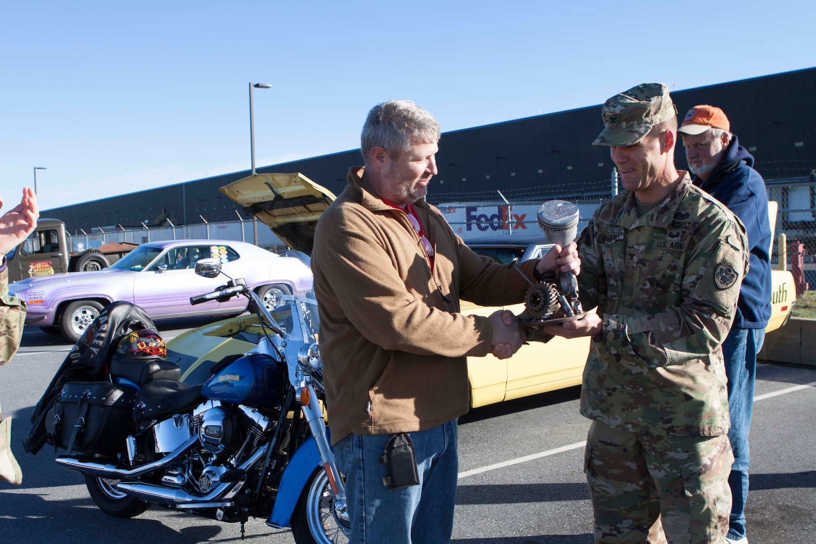 Army Col. Brad Eungard, DLA Distribution Susuquehanna, Pa., commander presents Paul Finn the “Rusty Piston” for his first place Harley Davidson at the CFC Car Show on October 28.