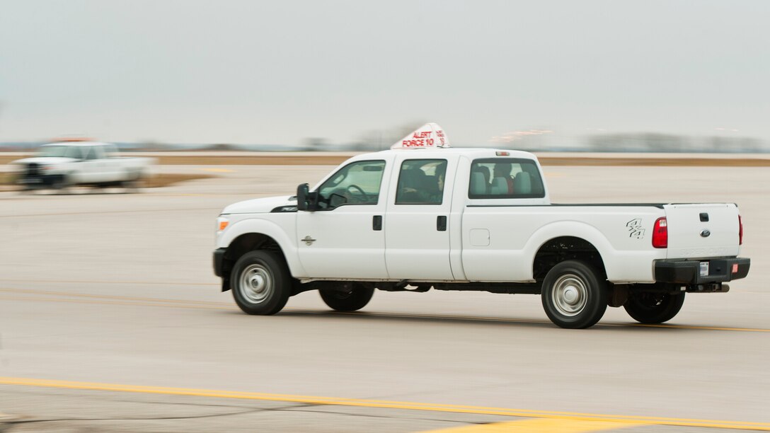 An alert vehicle speeds down the runway at Minot Air Force Base, N.D., Oct. 30, 2016, during exercise Global Thunder 17. Global Thunder is an annual training event that assesses command and control functionality in all U.S. Strategic Command mission areas and affords component commands a venue to evaluate their joint operational readiness. (U.S. Air Force photo/Airman 1st Class J.T. Armstrong)