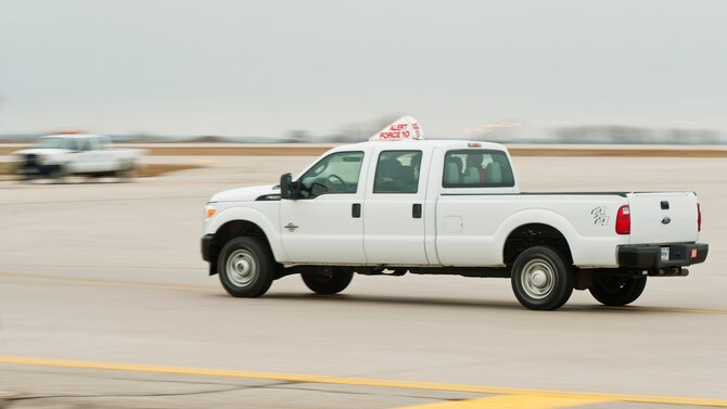 An alert vehicle speeds down the runway at Minot Air Force Base, N.D., Oct. 30, 2016, during exercise Global Thunder 17. Global Thunder is an annual training event that assesses command and control functionality in all U.S. Strategic Command mission areas and affords component commands a venue to evaluate their joint operational readiness. (U.S. Air Force photo/Airman 1st Class J.T. Armstrong)
