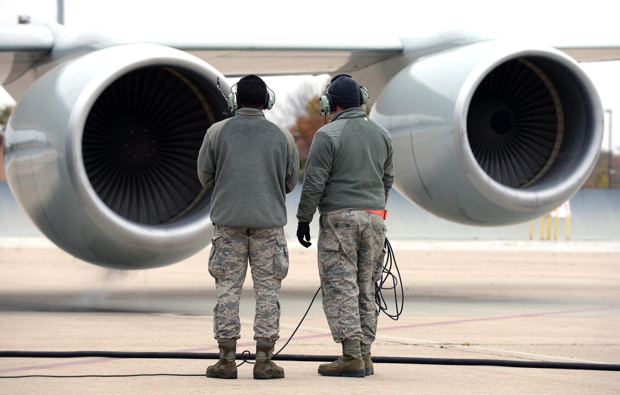 Airman First Class Kejion Madden-Vaughn (left) and Staff Sgt. Riley Neads (right), crew chiefs with the 55th Maintenance Group, observe an engine start during the launch of an RC-135 V/W Rivet Joint aircraft during Global Thunder 17, U.S. Strategic Command’s annual command post and field training exercise, Oct. 30, 2016, at Offutt Air Force Base, Neb. The exercise provided training opportunities for USSTRATCOM-tasked components, task forces, units and command posts to deter and, if necessary, defeat a military attack against the United States and to employ forces as directed by the President. (U.S. Air Force Photo by Delanie Stafford)