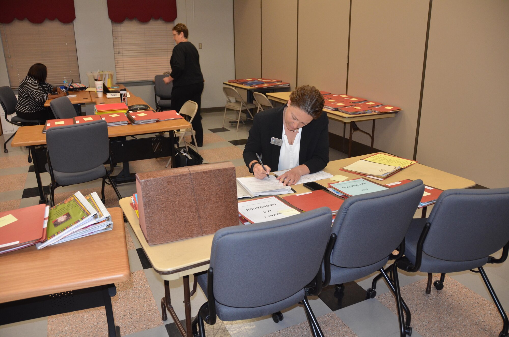 Alysse Seligman, youth specialist for the Air Force Services Activity, completes some paperwork during an annual inspection of JBSA-Fort Sam Houston’s Child Development Center. (U.S. Air Force Photo by Steve Warns)