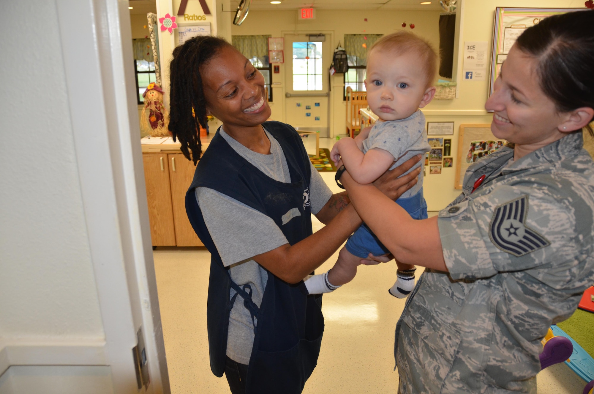 Technical Sgt. Crystal Dean drops off her son Isaiah, 6 months, to Denise Garces, lead teacher for JBSA-Fort Sam Houston’s Child Development Center. (U.S. Air Force Photo by Steve Warns)