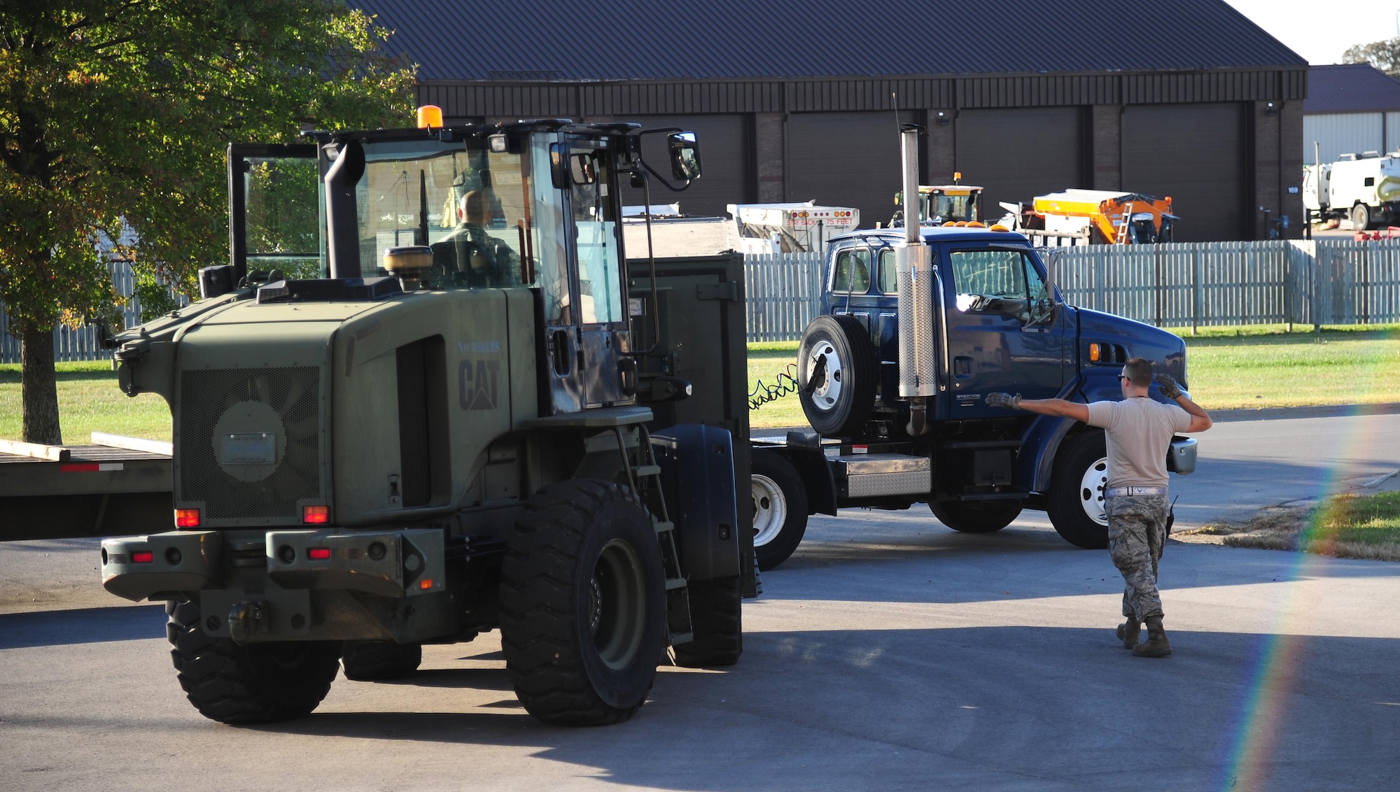 U.S. Air Force Senior Airman Robert Payne, a vehicle operator with the 509th Logistics Readiness Squadron, guides a fork-lift operator toward a truck to be loaded with personal protective equipment during exercise Global Thunder 17 (GT17) at Whiteman Air Force Base, Mo., Oct. 24, 2016. GT17 is an annual command and control exercise designed to train U.S. Strategic Command forces and assess joint operational readiness. (U.S. Air Force photo by Senior Airman Joel Pfiester)