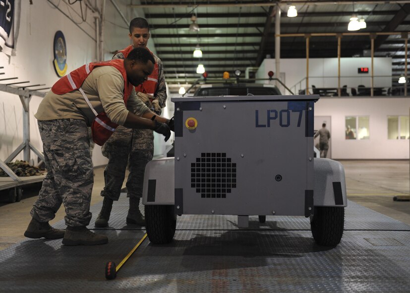 U.S. Air Force Staff Sgt. Adrian Marsh, front, and Airman 1st Class Marco Espindola, 509th Logistics Readiness Squadron augumentees, check the weight of equipment during Exercise Global Thunder 17 (GT17) at Whiteman Air Force Base, Mo., Oct. 25, 2016. The weight of the equipment is recorded to ensure proper balance of the aircraft during flight. GT17 is an annual command and control exercise designed to train U.S. Strategic Command forces and assess joint operational readiness. (U.S. Air Force Senior Airman Danielle Quilla)