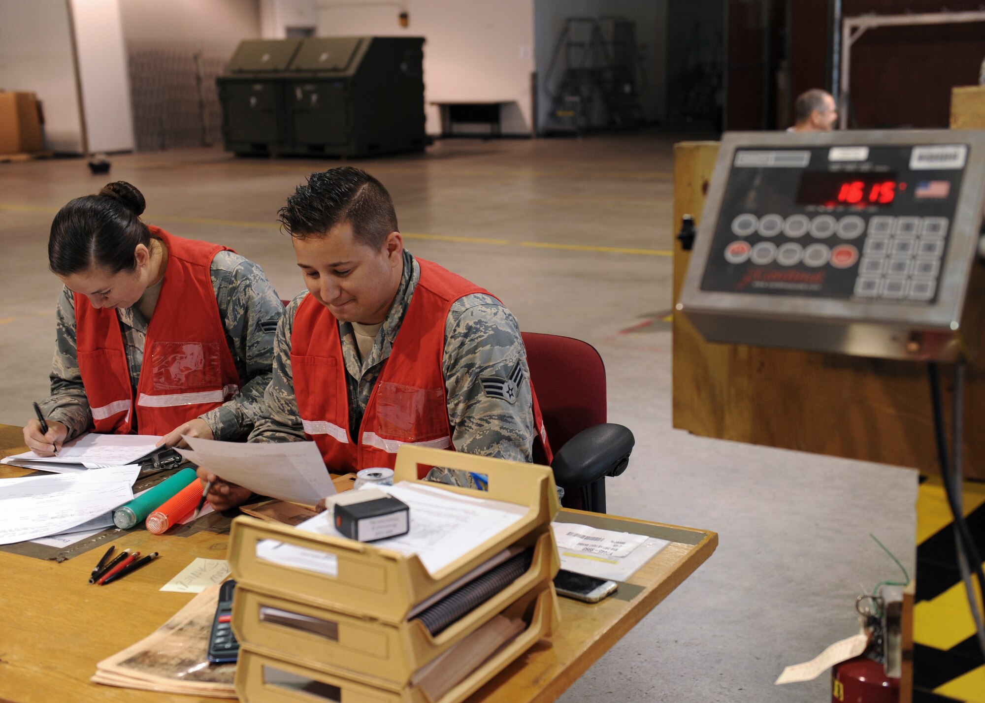 U.S. Air Force Airman 1st Class Ashley Clancy ,left, and Airman 1st Class Dominic Jarman ,right, 509th Logistic Readiness Squadron (LRS) augumentees, annotate data at the weighing station during Exercise Global Thunder 17 (GT17) at Whiteman Air Force Base, Mo., Oct. 25, 2016. Airmen were augmented from different sections of LRS to support the deployment mission. GT17 is an annual command and control exercise designed to train U.S. Strategic Command forces and assess joint operational readiness.  (U.S. Air Force Senior Airman Danielle Quilla)