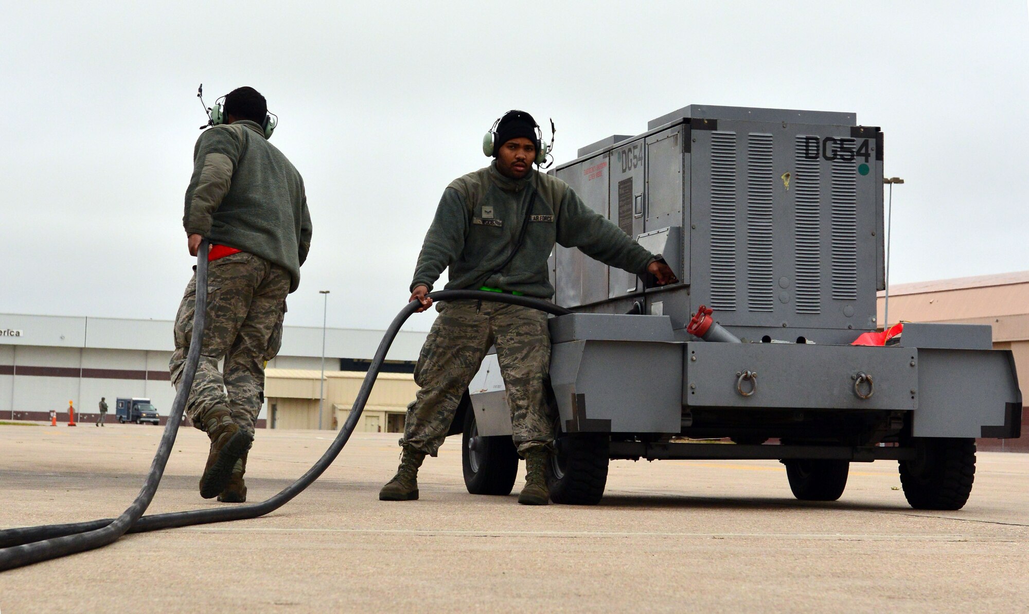 Airman First Class Kejion Madden-Vaughn (left) and Airman First Class Clinton Woods III (right), crew chiefs with the 55th Maintenance Group, shut-down and prepare to move a ground power unit while launching an RC-135 V/W Rivet Joint aircraft during Global Thunder 17, U.S. Strategic Command’s annual command post and field training exercise, Oct. 30, 2016, at Offutt Air Force Base, Neb. The exercise provided training opportunities for USSTRATCOM-tasked components, task forces, units and command posts to deter and, if necessary, defeat a military attack against the United States and to employ forces as directed by the President. (U.S. Air Force Photo by Drew Nystrom)