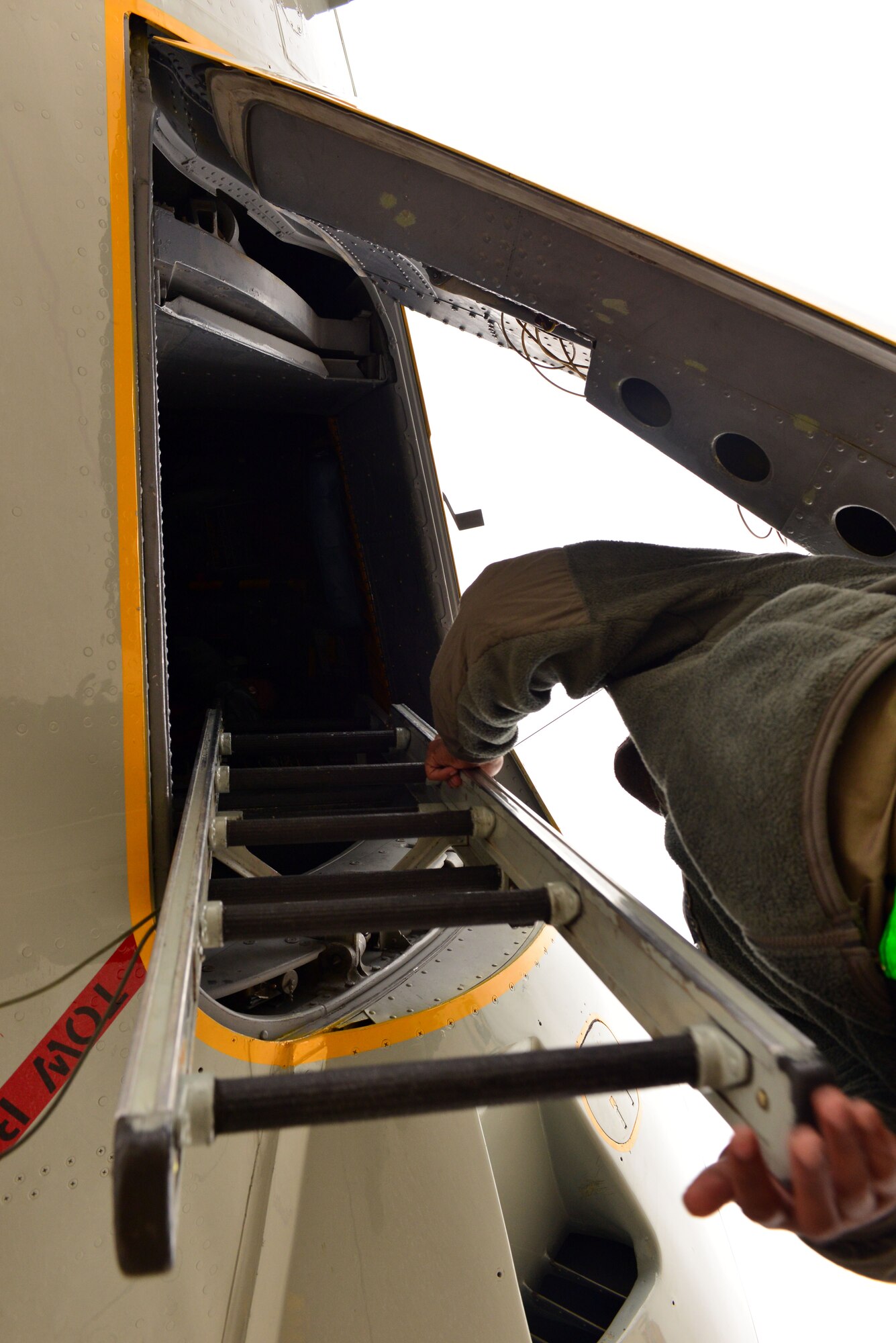 Airman First Class Clinton Woods III, a crew chief with the 55th Maintenance Group, stows the crew entry ladder while preparing to launch an RC-135 V/W Rivet Joint aircraft during Global Thunder 17, U.S. Strategic Command’s annual command post and field training exercise, Oct. 30, 2016, at Offutt Air Force Base, Neb. The exercise provided training opportunities for USSTRATCOM-tasked components, task forces, units and command posts to deter and, if necessary, defeat a military attack against the United States and to employ forces as directed by the President. (U.S. Air Force Photo by Drew Nystrom)