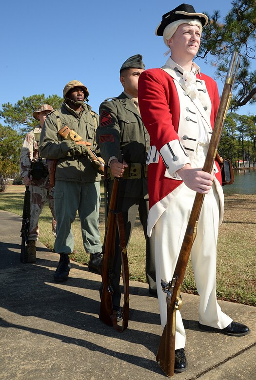 Marines showcase various uniforms throughout Marine Corps history during a birthday pageant at Covella Pond aboard Marine Corps Logistics Base Albany, Nov. 1.