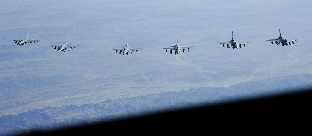 Six F-16 Fighting Falcons fly in formation after refueling from a KC-135 Stratotanker Oct. 28, 2016. The air refueling was observed by Airmen from the 379th Air Expeditionary Wing who took part in an orientation flight on the KC-135. (U.S. Air Force Photo by Senior Airman Cynthia A. Innocenti)