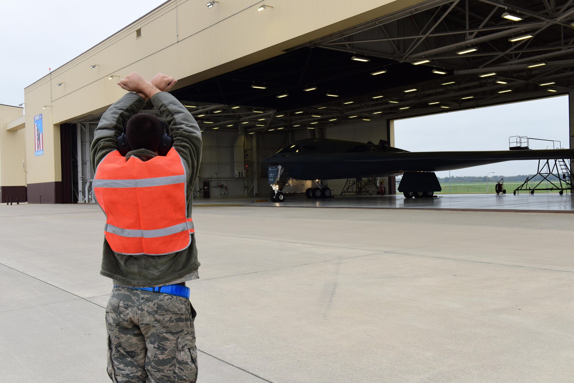 A crew chief assigned to the 509th Aircraft Maintenance Squadron  marshalls a B-2 Spirit out of its dock during Exercise Global Thunder 17 at Whiteman Air Force Base, Mo., Oct 30, 2016, during exercise Global Thunder 17. AFGSC supports U.S. Strategic Command's (USSTRATCOM) global strike and nuclear deterrence missions by providing strategic assets, including bombers like the B-52 and B-2, to ensure a safe, secure, effective and ready deterrent force. Global Thunder is an annual training event that assesses command and control functionality in all USSTRATCOM mission areas and affords component commands a venue to evaluate their joint operational readiness.(U.S. Air Force photo by Airman Michaela Slanchik)