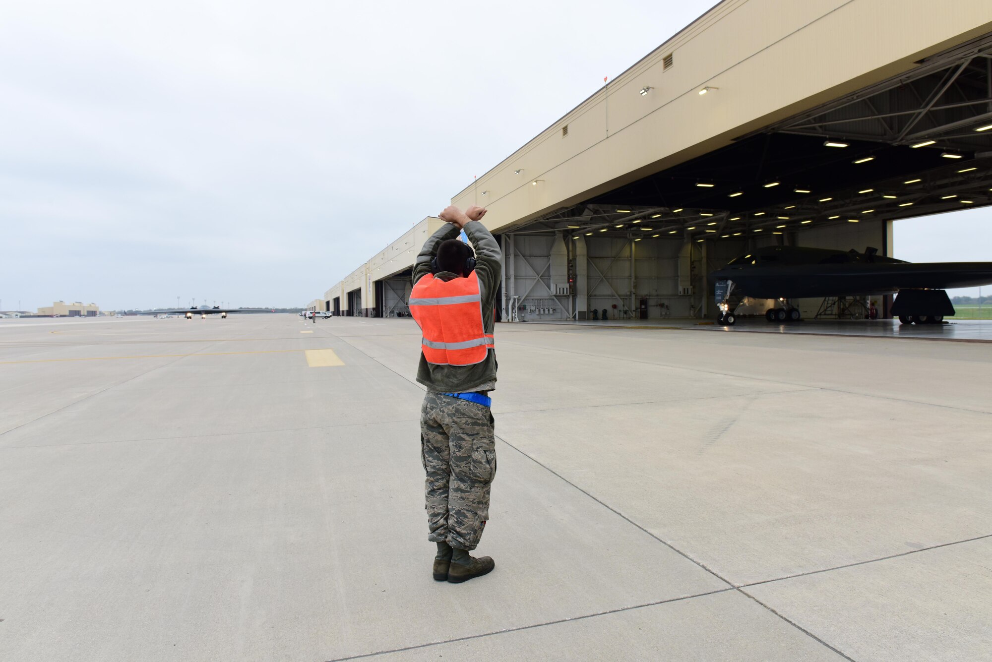 A crew chief assigned to the 509th Aircraft Maintenance Squadron  marshalls a B-2 Spirit out of its dock during Exercise Global Thunder 17 at Whiteman Air Force Base, Mo., Oct 30, 2016, during exercise Global Thunder 17. AFGSC supports U.S. Strategic Command's (USSTRATCOM) global strike and nuclear deterrence missions by providing strategic assets, including bombers like the B-52 and B-2, to ensure a safe, secure, effective and ready deterrent force. Global Thunder is an annual training event that assesses command and control functionality in all USSTRATCOM mission areas and affords component commands a venue to evaluate their joint operational readiness.(U.S. Air Force photo by Airman Michaela Slanchik)