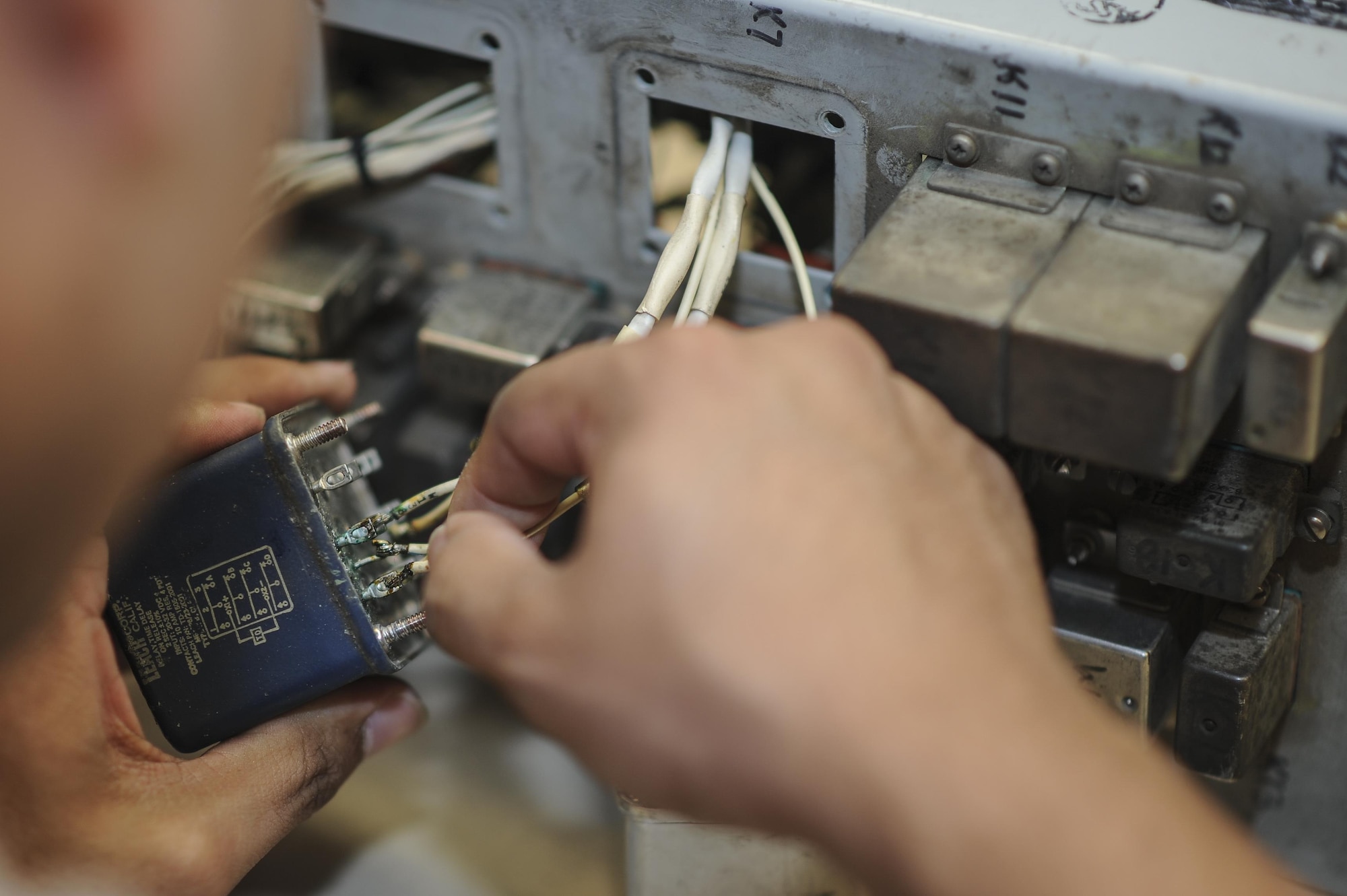 Staff Sgt. Vincent Cruz, 355th Maintenance Group Air Force repair enhancement program technician, solders a replacement relay for an armament relay box that controls some of the A-10 weapons systems at Davis-Monthan Air Force Base, Ariz., Oct. 25, 2016. AFREP is not intended to replace any formal repair process but to enhance localized repair capability. (U.S. Air Force photo by Airman 1st Class Mya M. Crosby)