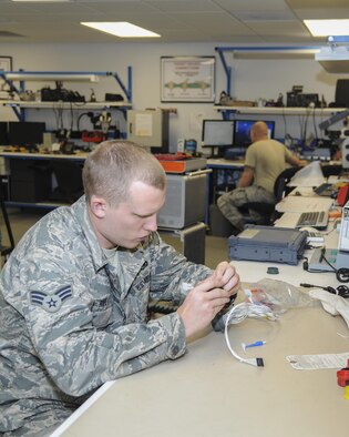 Senior Airman Ryan Rife, 355th Maintenance Group Air Force repair enhancement technician, repairs a burnt connector for an Armament shop tester used to function check weapons system components at Davis-Monthan Air Force Base, Ariz., Oct. 25, 2016. D-M’s AFREP avoided over a hundred thousand dollars in replacement costs. (U.S. Air Force photo by Airman 1st Class Mya M. Crosby)