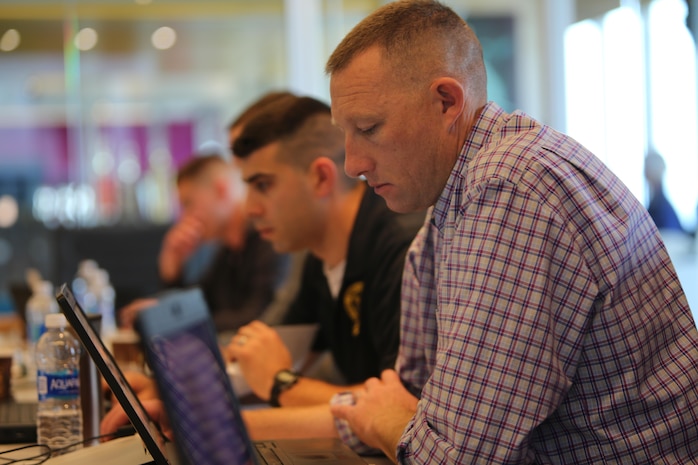 The early board members input their calculated scores and votes into the Marine Corps Recruiting Information System to determine which applicants receive the Naval Reserve Officers Training Corps Marine scholarship, Oct. 26, 2016, at the J. Walter Thompson building in Atlanta, Ga. The early board determined who received 21 of the 51 scholarships allotted to 9th Marine Corps District.  (U.S. Marine Corps photo by Cpl. Jennifer Webster/Released)