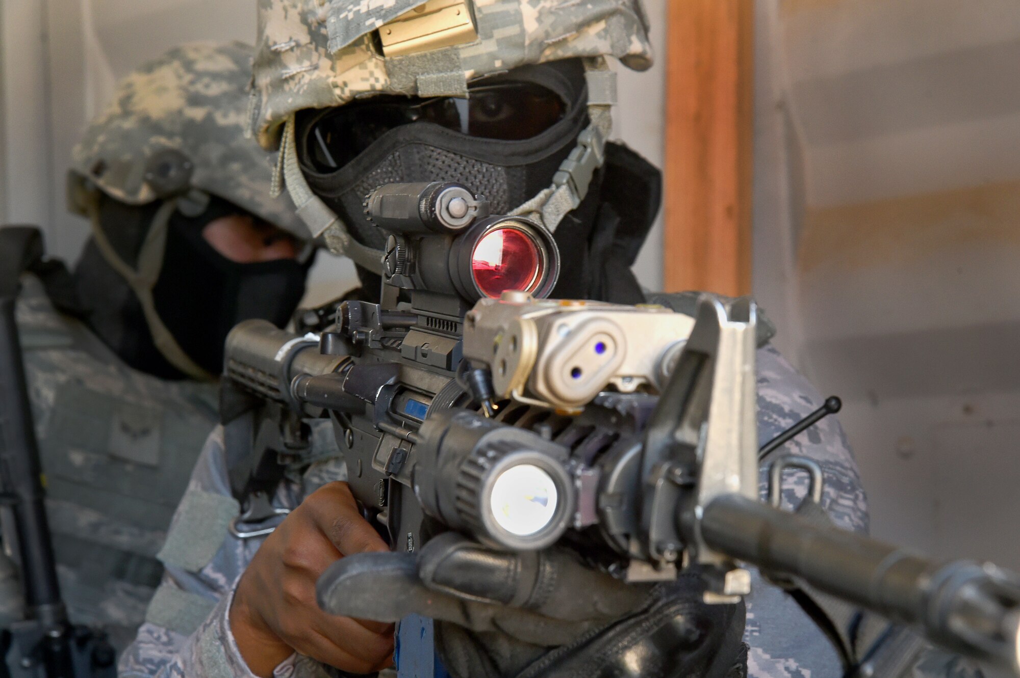 An Airman assigned to the 799th Security Forces Squadron secures an entrance point during a Fundamentals of Proficiency Fire and Close Quarters Battle course, Oct. 21, 2016, at Range 63C, Silver Flag Alpha, Nev. Airmen were evaluated on their planning, communication, teamwork, execution and effectiveness during simulated operations. (U.S. Air Force photo by Airman 1st Class James Thompson) 