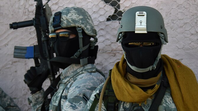 Airmen assigned to the 799th Security Forces Squadron hold their positions and await orders during a Fundamentals of Proficiency Fire and Close Quarters Battle course Oct. 21, 2016, at Range 63C, Silver Flag Alpha, Nev. Airmen were tested and evaluated on combat tactics, strategic planning, communication and leadership through various training scenarios. (U.S. Air Force photo by Airman 1st Class James Thompson) 