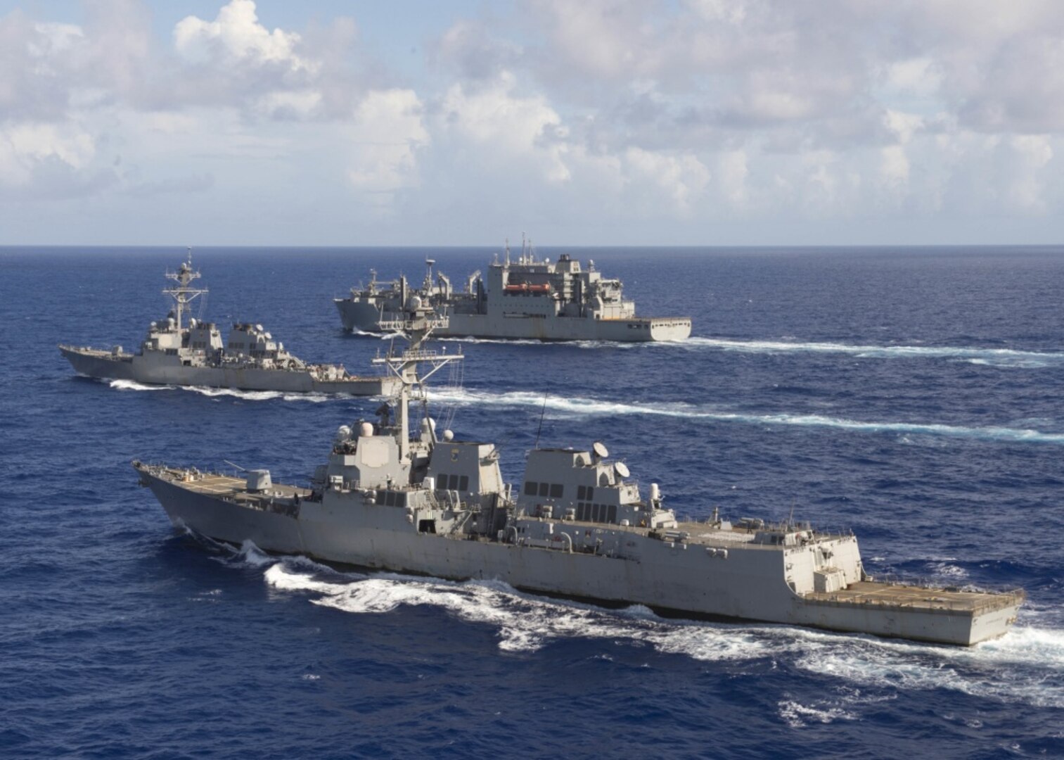 The guided-missile destroyers USS Spruance, front, USS Decatur and the Military Sealift Command fleet oiler USNS Carl Brashear steam in formation in the Pacific Ocean with the U.S. Air Force 34th Expeditionary Bomb Squadron from Anderson Air Force Base, Guam, following a joint exercise, Oct. 27, 2016. The Spruance and Decatur and the guided-missile destroyer USS Momsen, along with embarked “Warbirds” and “Devilfish” detachments of Helicopter Maritime Strike Squadron 49, are deployed in support of maritime security and stability in the Indo-Asia-Pacific region as part of a U.S. 3rd Fleet Pacific Surface Action Group under the commander of Destroyer Squadron 31. Navy photo by Petty Officer 2nd Class Will Gaskill