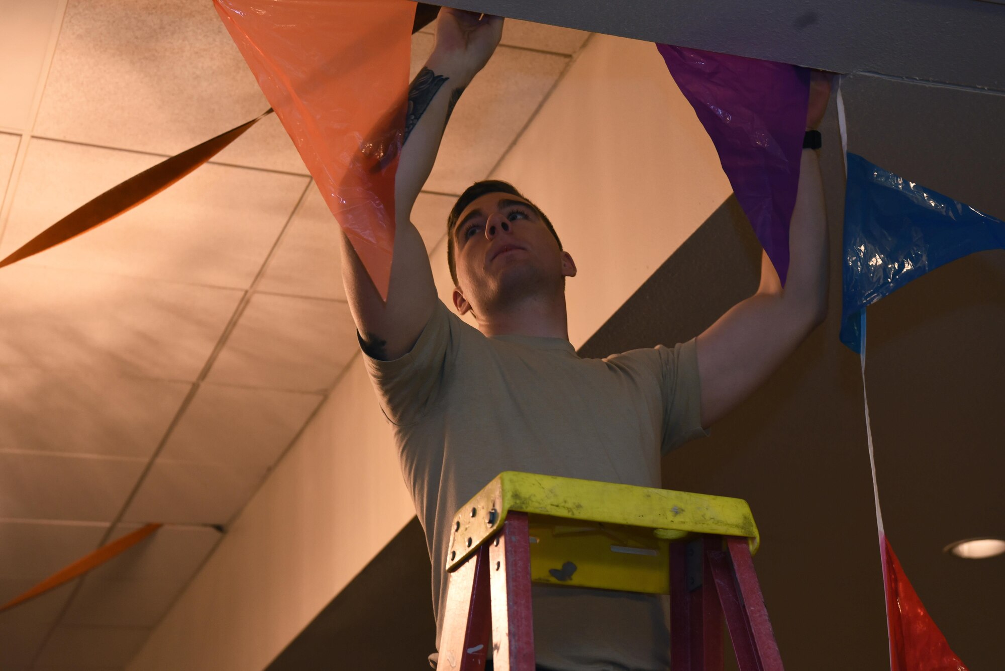 Senior Airman Daniel Tinsley, 790th Missile Security Forces Squadron tactical response force assaulter, hangs up decorations in the Trail’s End at F.E. Warren Air Force Base, Wyo., Oct. 27, 2016. Tinsley and other Airmen helped set up for an upcoming event. (Airman 1st Class Breanna Carter)
