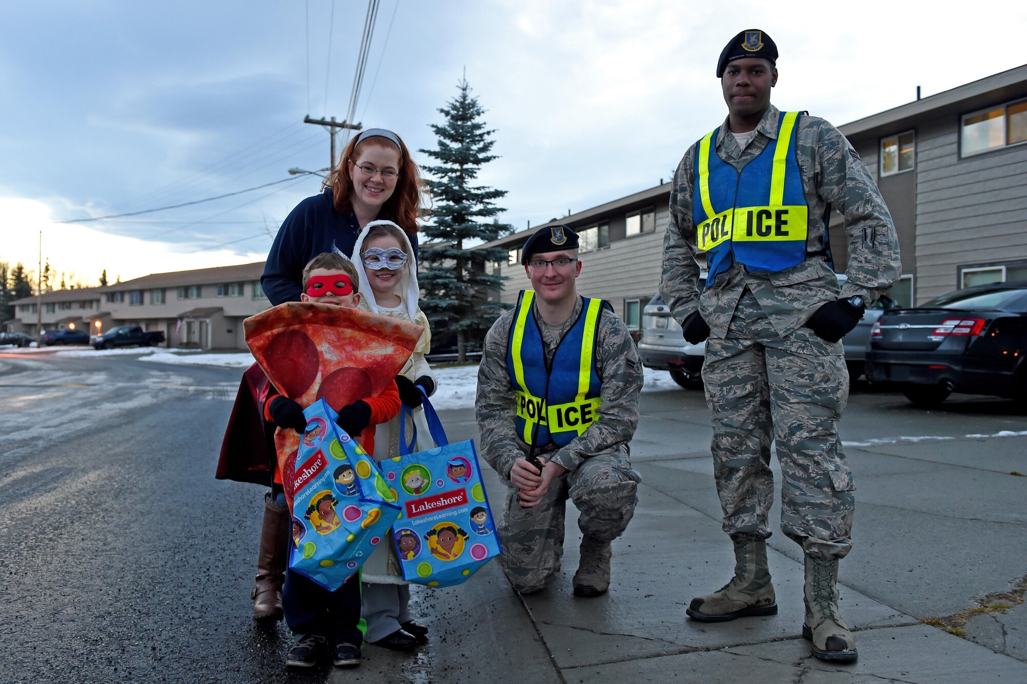 Airman 1st Class Davis Lavance and Airman 1st Class Justin Rippentrop, entry controllers with the 673d Security Forces Squadron, meet trick-or-treaters at Chugach housing community at Joint Base Elmendorf-Richardson, Oct. 31, 2016. Members of the 673d SFS participated in Pumpkin Patrol, an annual event which provides an increased police presence throughout base housing – affording candy enthusiasts a secure environment to trick-or-treat. 