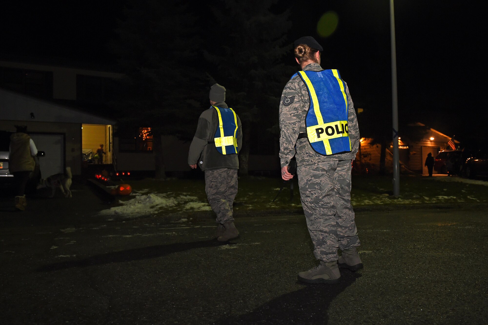 Staff Sgt. Jacob McQuillen, 673d Security Forces Squadron patrolman, and Tech. Sgt. Sarah Qualle, 673d SFS noncommissioned officer in charge of police services, patrol Cherry Hill housing community Oct. 31, 2016. Members of the 673d SFS participated in Pumpkin Patrol, an annual event which provides an increased police presence throughout base housing – affording candy enthusiasts a secure environment to trick-or-treat. 
