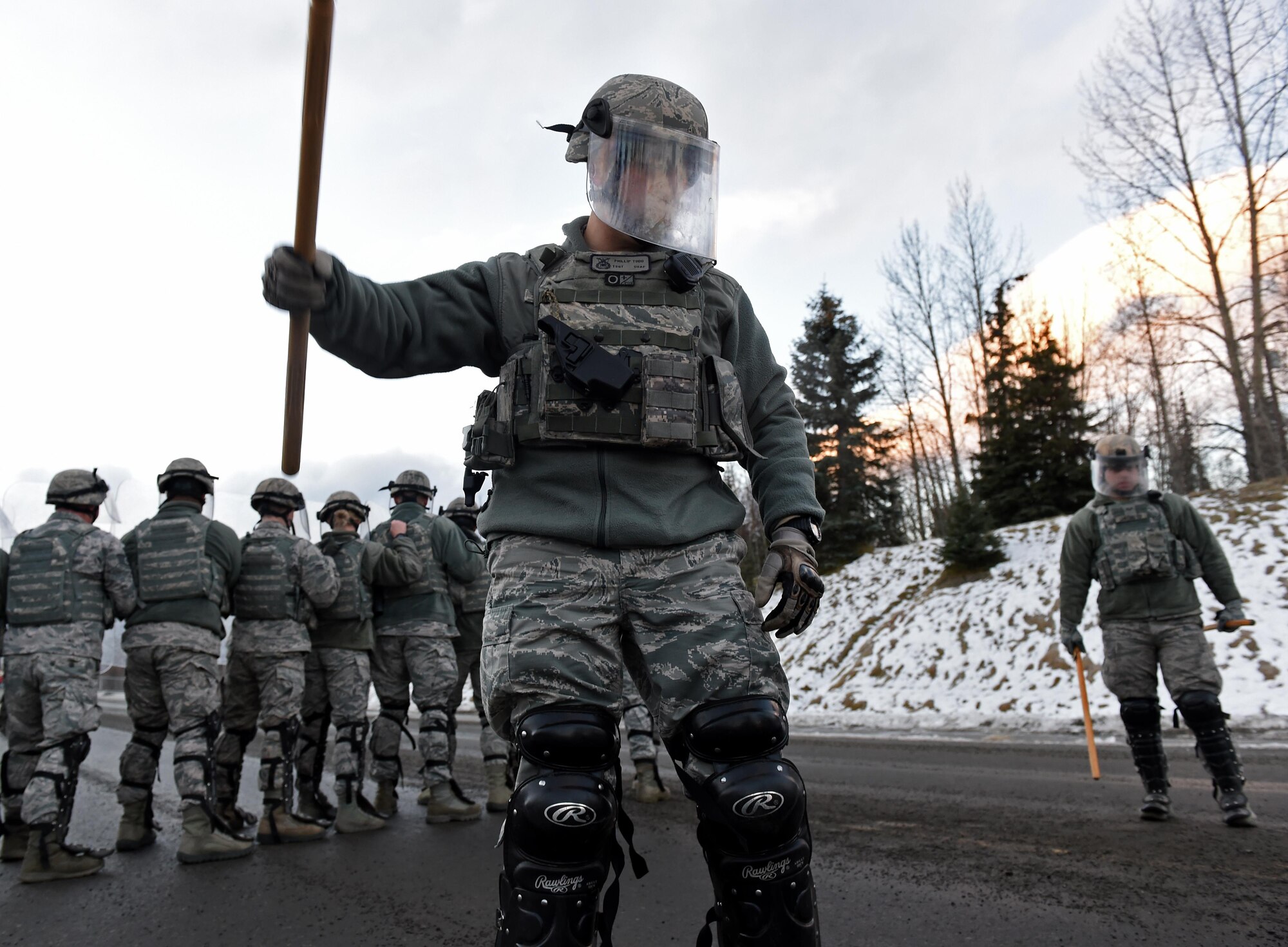 Joint Base Elmendorf-Richardson security forces personnel perform security operations during a simulated protest as part of exercise Polar Force 17-1 at JBER, Alaska, Nov. 1, 2016. The simulated protest began as a peaceful demonstration which escalated, resulting in a few aggressive protesters being detained and turned over to local law enforcement. The exercise tests the base's ability to integrate, mobilize, and prepare assigned personnel, aircraft and equipment for a wartime mission and to employ forces and weapons systems.