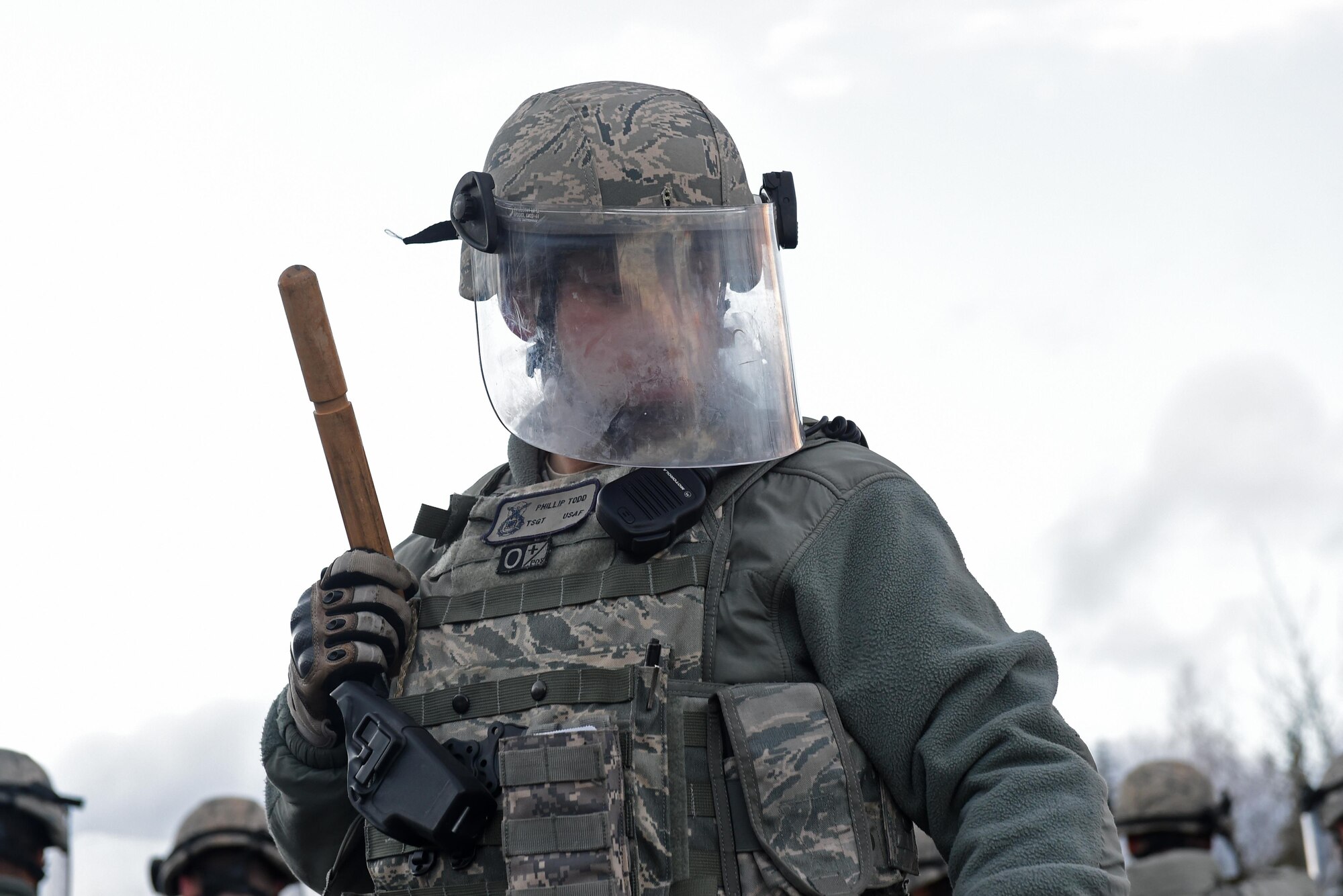 Technical Sgt. Todd Phillip, a unit training manager with the 673d Security Forces Squadron, performs security operations during a simulated protest as part of exercise Polar Force 17-1 at JBER, Alaska, Nov. 1, 2016. The simulated protest began as a peaceful demonstration which escalated, resulting in a few aggressive protesters being detained and turned over to local law enforcement. The exercise tests the base's ability to integrate, mobilize, and prepare assigned personnel, aircraft and equipment for a wartime mission and to employ forces and weapons systems. 