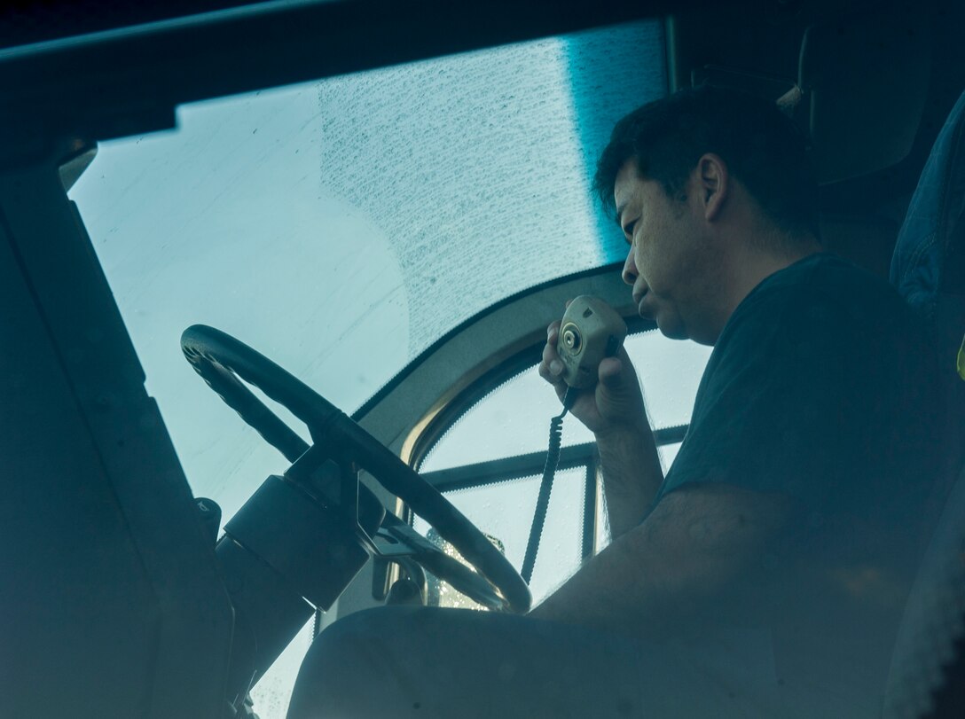 Masao Itokazu, 18th Civil Engineer Squadron driver operator, conducts radio checks inside an Oshkosh Striker 6x6 Oct. 31, 2016, at Kadena Air Base, Japan. Properly functioning radio systems assist with optimum response time in the event of an aircraft incident. (U.S. Air Force photo by Senior Airman Lynette M. Rolen)