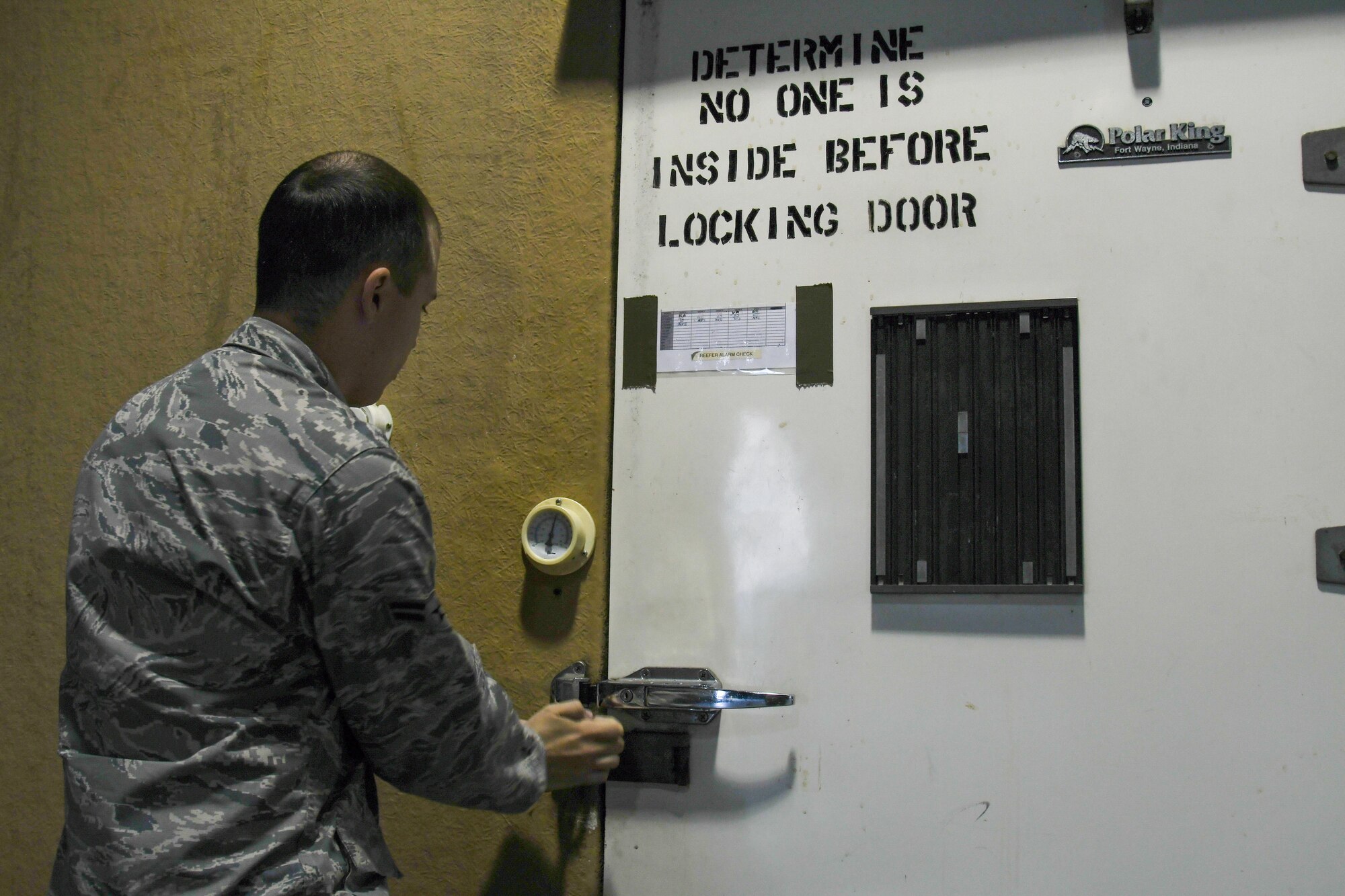 U.S. Air Force Airman 1st Class Kevin Johnston, 731st AMS special planning technician, locks a cryogenic storage area at Osan Air Base, Republic of Korea, Nov. 2, 2016. The special handlers utilize the storage area to provide to the mortuary affairs capability of the ROK. (U.S. Air Force photo by Senior Airman Dillian Bamman)
