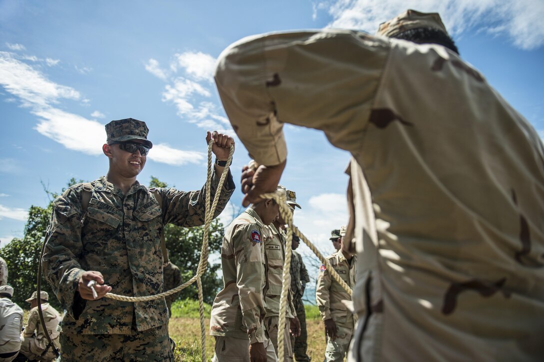 Marine Corps Lance Cpl. Diego Fuentes shows Cambodian sailors how to prepare a knot for assembling a Zodiac boat during Cooperation Afloat Readiness and Training Cambodia 2016 in Sihanoukville, Cambodia, Nov. 1, 2016. The exercises occur among the U.S. Navy, U.S. Marine Corps and the armed forces of nine partner nations, including Bangladesh, Brunei, Cambodia, Indonesia, Malaysia, the Philippines, Singapore, Thailand and Timor-Leste. Navy photo by Petty Officer 1st Class Benjamin A. Lewis