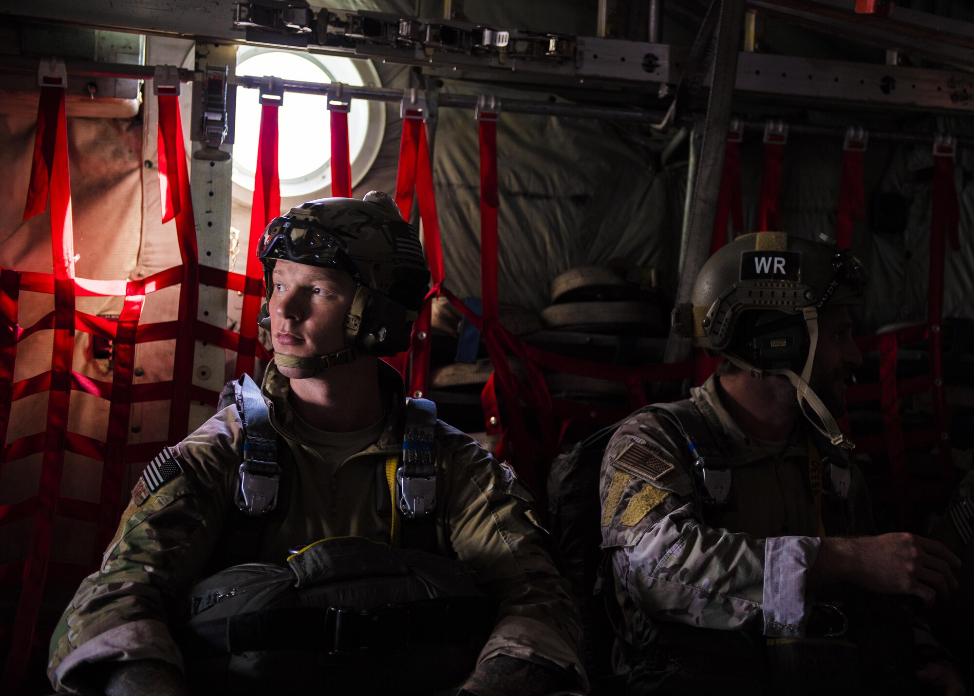 374th Operations Support Squadron survival, evasion, resistance and escape specialists wait to perform a static line parachute jump out of a C-130 Hercules on 26 Oct. 2016, at Yokota Air Base, Japan. The SERE specialists are trained for contingency situations, such as evading and escaping capture behind enemy lines. (U.S. Air Force photo by Airman 1st Class Donald Hudson/Released)