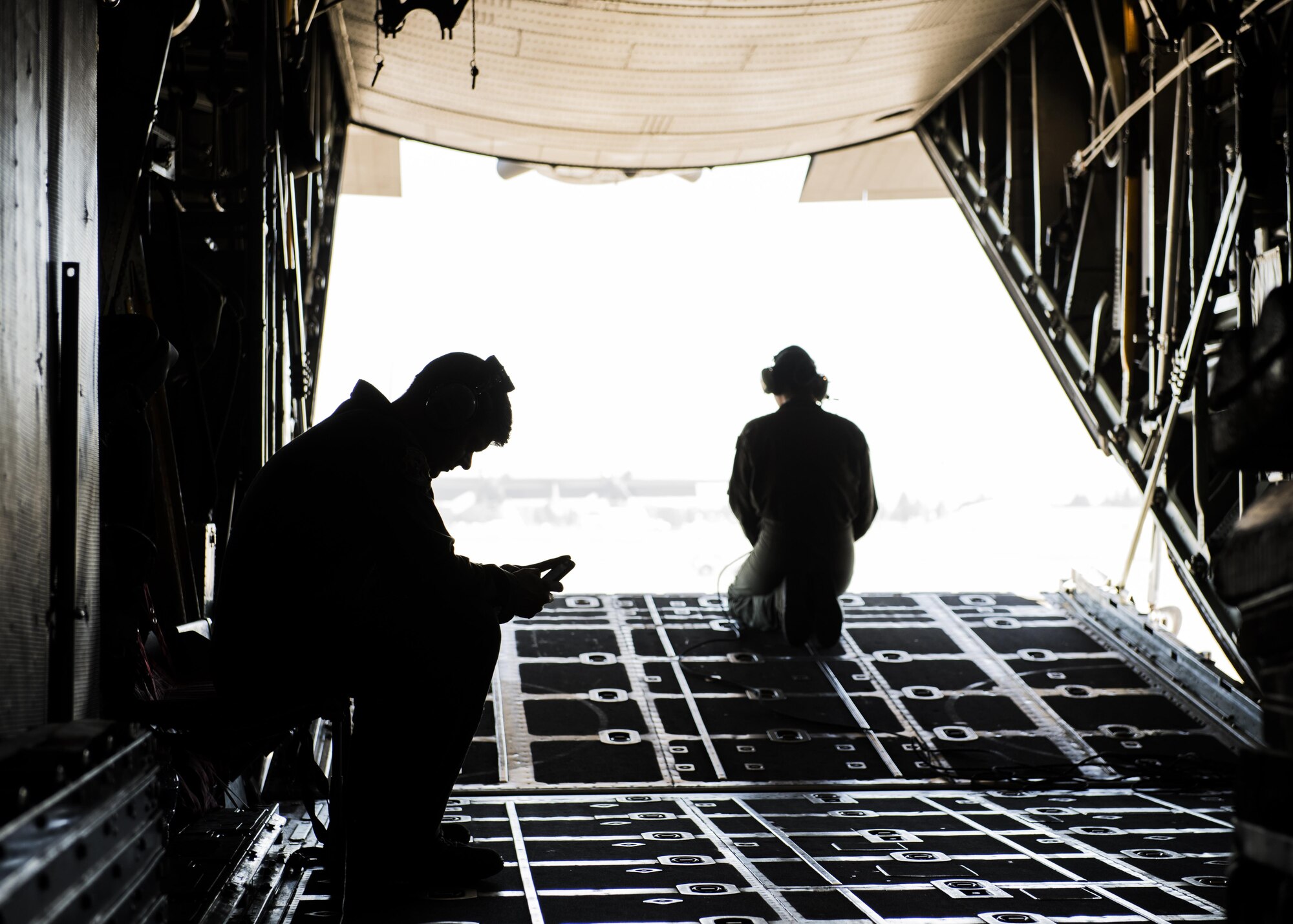 Loadmasters wait for takeoff during a personnel drop training exercise in a C-130 Hercules on 26 Oct. 2016 at Yokota Air Base, Japan. The training not only allowed the survival, evasion, resistance and escape personnel to practice jumping, it helped loadmasters and other aircrew members perform personnel drop training. (U.S. Air Force photo by Airman 1st Class Donald Hudson/Released)