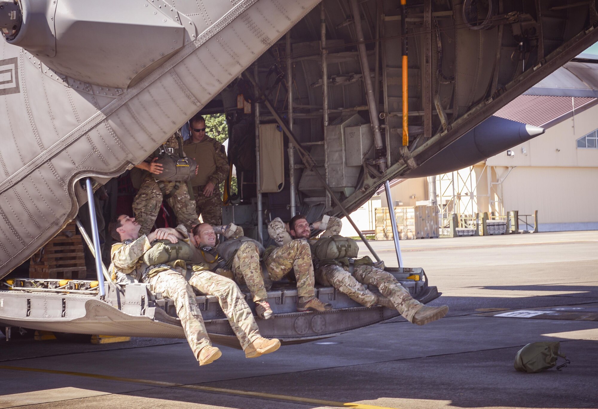 Survival, Evasion, Resistance and Escape specialists relax on a C-130 Hercules before takeoff at Yokota Air Base, Japan, Oct. 26, 2016. SERE specialists from across Pacific Command convened to share knowledge and experience to help homogenize effective practices across the various commands. (U.S. Air Force photo by Airman 1st Class Elizabeth Baker/Released)
