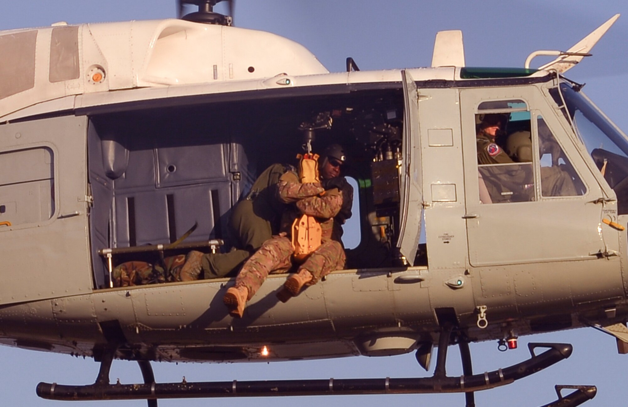 Tech. Sgt. Venie Joshua, 353rd Special Operations Support Squadron, is hoisted into a UH-1 Iroquois helicopter at Camp Fuji, Japan, Oct. 26, 2016. Joshua was one of the Survival, Evasion, Resistance and Escape trainees who received hoist training to meet qualifications and sharpen the skills of all related personnel. (U.S. Air Force photo by Airman 1st Class Elizabeth Baker/Released)