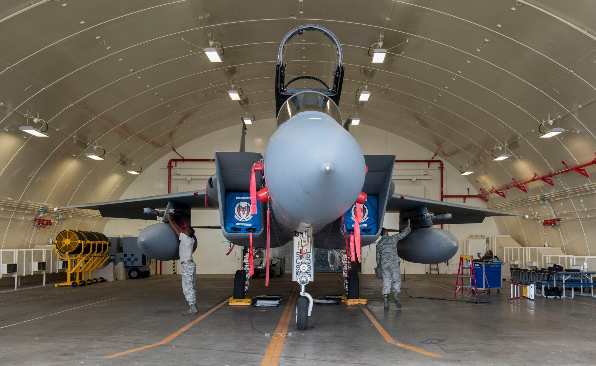 U.S. Air Force Staff Sgt. Nicholas McCants and Airman 1st Class Kalon Lobbins, 44th Aircraft Maintenance Unit load crew members, prepare for weapons load training Nov. 2, 2016, at Kadena Air Base, Japan. To maintain certification as load crew members, Airmen must go through monthly evaluations. (U.S. Air Force photo by Senior Airman Lynette M. Rolen/Released)
